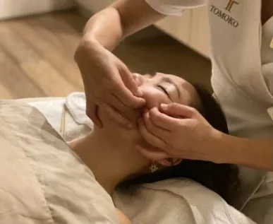 A therapist performing a Bigan facial massage