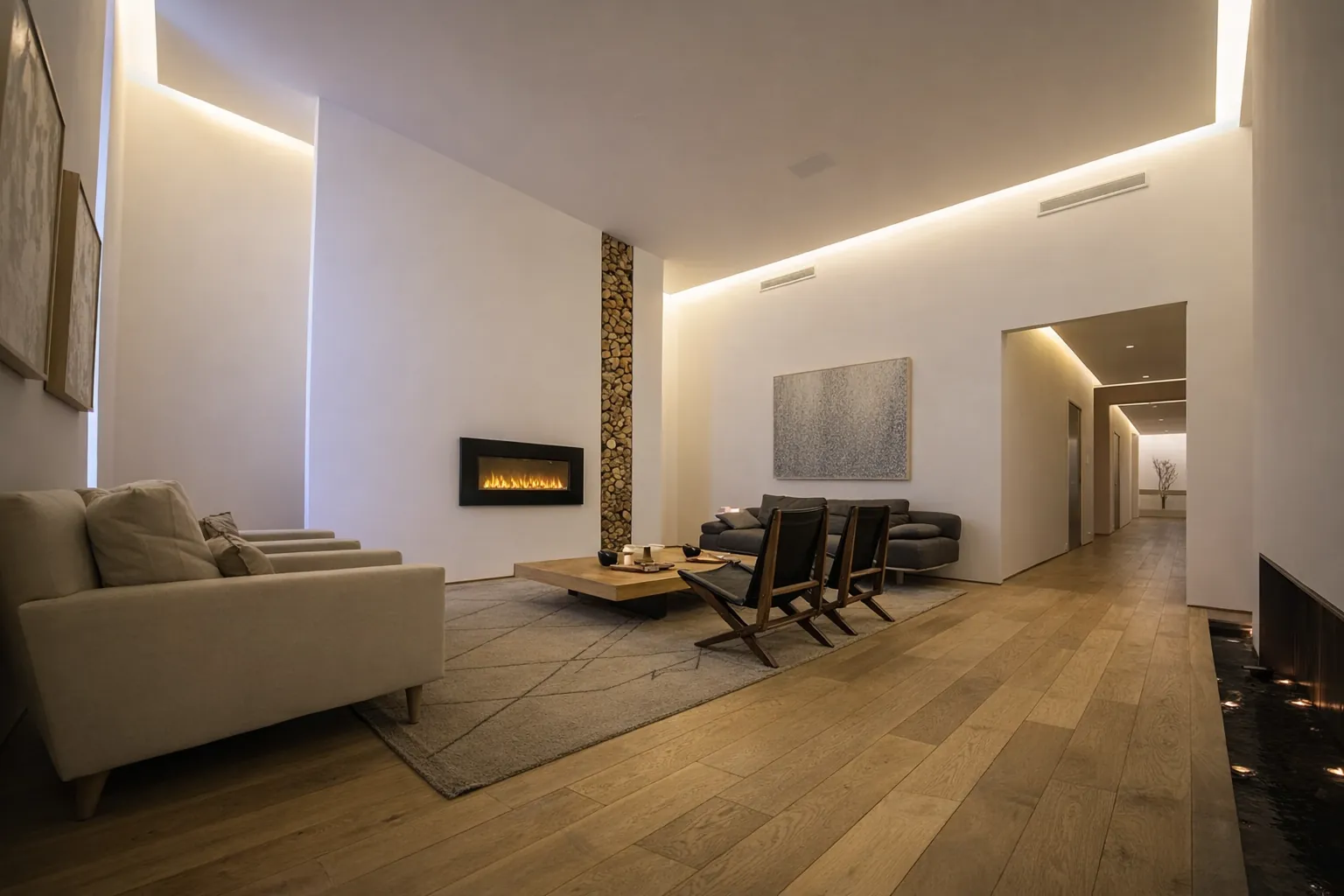 The lounge, with a fireplace, a wall of stacked wood and soft cove lighting