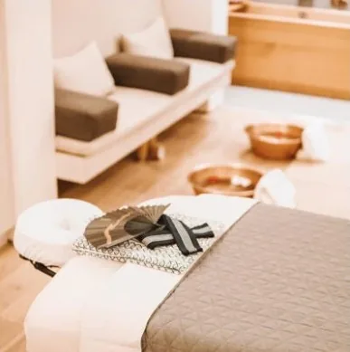 A treatment suite prepared with a folded fan and warm copper foot basins